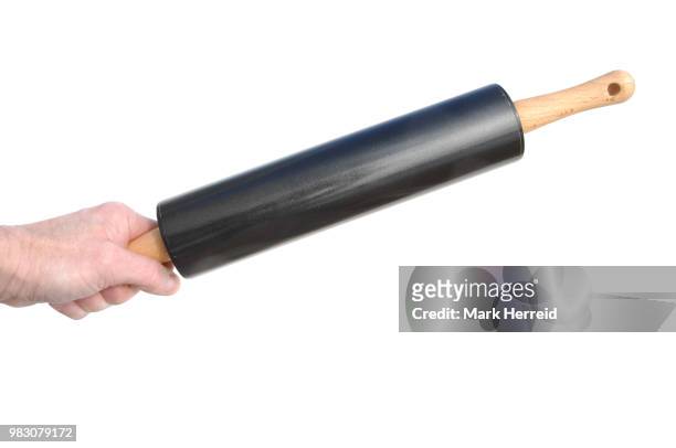 hand holding a rolling pin - rolling pin stock-fotos und bilder