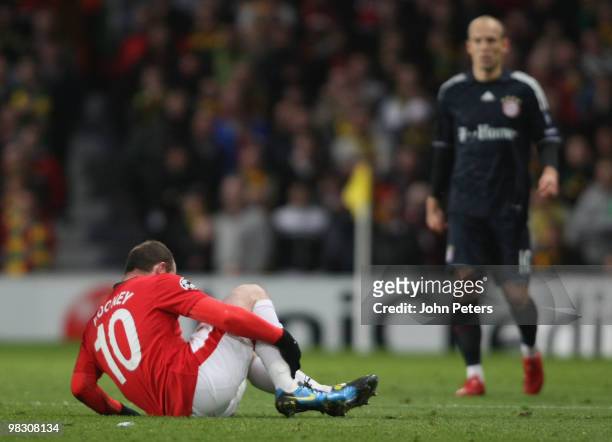Wayne Rooney of Manchester United appears to injure his ankle during the UEFA Champions League Quarter-Final Second Leg match between Manchester...