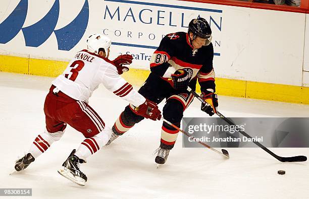 Marian Hossa of the Chicago Blackhawks controls the puck as Keith Yandle of the Phoenix Coyotes defends at the United Center on March 23, 2010 in...