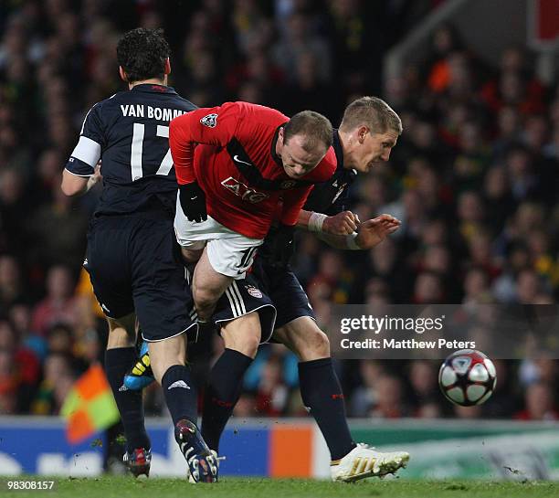 Wayne Rooney of Manchester United clashes with Mark van Bommel and Bastian Schweinsteiger of Bayern Munich during the UEFA Champions League...