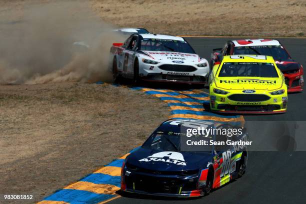 Alex Bowman, driver of the Axalta Chevrolet, leads a pack of cars as Brad Keselowski, driver of the Discount Tire Ford, drives off track during the...