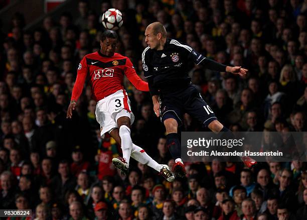 Arjen Robben of Bayern Muenchen competes for the ball in the air with Patrice Evra of Manchester United during the UEFA Champions League Quarter...