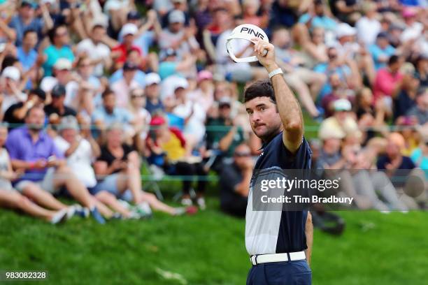 Bubba Watson of the United States waves to the gallery after making a putt for birdie on the 18th green during the final round of the Travelers...