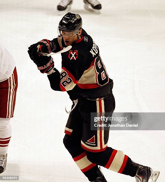 Tomas Kopecky of the Chicago Blackhawks turns to see the puck against the Phoenix Coyote bench at the United Center on March 23, 2010 in Chicago,...