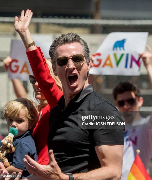 California gubernatorial candidate Gavin Newsom reacts to a cheering crowd during the San Francisco gay pride parade in San Francisco, California on...