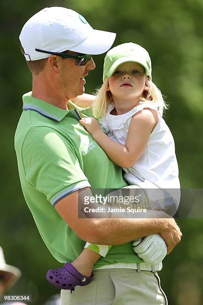 Henrik Stenson of Sweden waits with his daughter Lisa during the Par 3 Contest prior to the 2010 Masters Tournament at Augusta National Golf Club on...