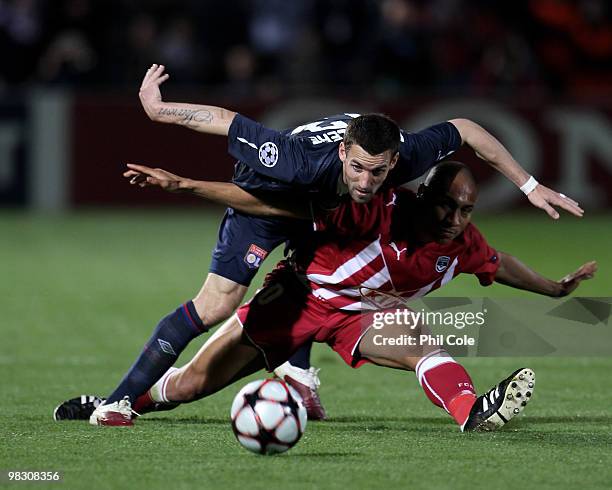 Anthony Reveillere of Olympique Lyonnais is challenged by Jussie of Bordeaux during the UEFA Champions League quarter final second leg match between...