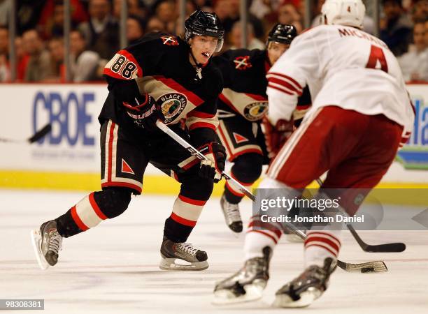 Patrick Kane of the Chicago Blackhawks skates up the ice towards Zbynek Michalek of the Phoenix Coyotes at the United Center on March 23, 2010 in...