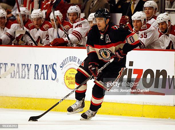 Patrick Sharp of the Chicago Blackhawks controls the puck in front of the Phoenix Coyote bench at the United Center on March 23, 2010 in Chicago,...