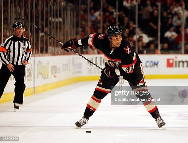 Dustin Byfuglien of the Chicago Blackhawks prepares to shoot against the Phoenix Coyotes at the United Center on March 23, 2010 in Chicago, Illinois....