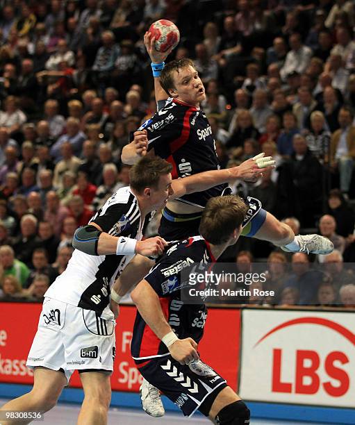 Filip Jicha of Kiel challenges Oscar Carlen of Flensburg-Handewitt during the Toyota Handball Bundesliga match between THW Kiel and SG...