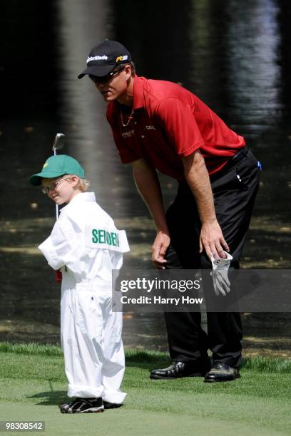 John Senden of Australia watches his Jacob hit a putt during the Par 3 Contest prior to the 2010 Masters Tournament at Augusta National Golf Club on...