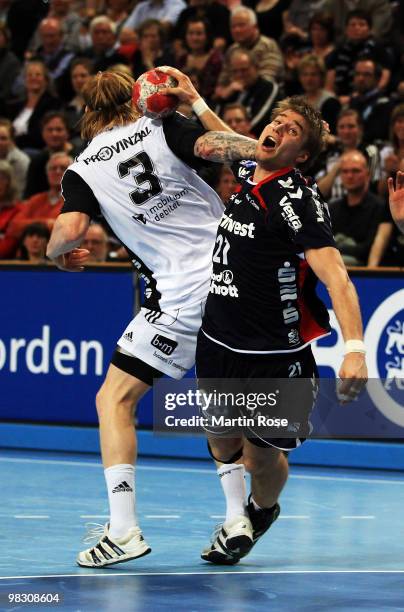 Boerge Lund of Kiel challenges Jacon Heinl of Flensburg-Handewitt during the Toyota Handball Bundesliga match between THW Kiel and SG...