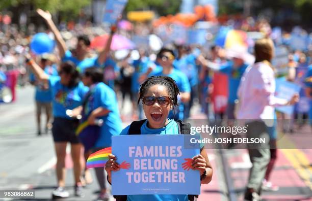 She Givens holds up a sign while marching during the San Francisco gay pride parade in San Francisco, California on June 2018.