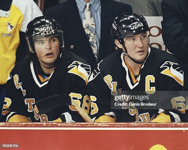 Mario Lemieux and Jaromir Jagr of the Pittsburgh Penguins sit on the bench during the game against the Montreal Canadiens in the 1990's at the...