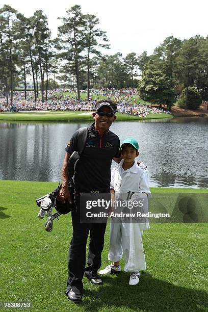 Thongchai Jaidee of Thailand poses with his caddie during the Par 3 Contest prior to the 2010 Masters Tournament at Augusta National Golf Club on...