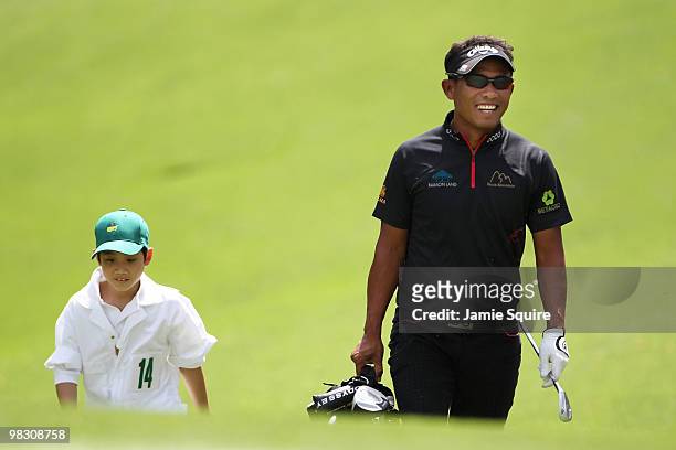 Thongchai Jaidee of Thailand walks with his caddie during the Par 3 Contest prior to the 2010 Masters Tournament at Augusta National Golf Club on...