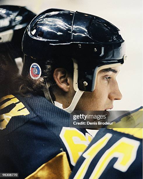 Mario Lemieux of the Pittsburgh Penguins sits on the bench during the game against the Montreal Canadiens in the 1990's at the Montreal Forum in...