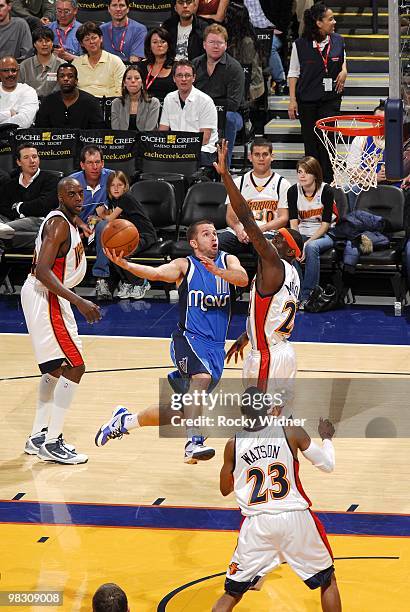 Jose Barea of the Dallas Mavericks drives to the basket for a layup against Anthony Morrow and C.J. Watson of the Golden State Warriors during the...