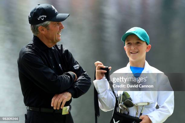 Gary Player of South Africa waits with his caddie during the Par 3 Contest prior to the 2010 Masters Tournament at Augusta National Golf Club on...