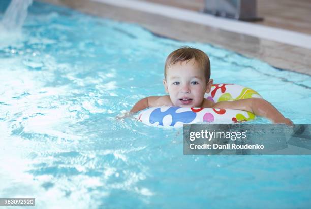 kid learns to swim using a plastic water ring - plastic ring stock pictures, royalty-free photos & images