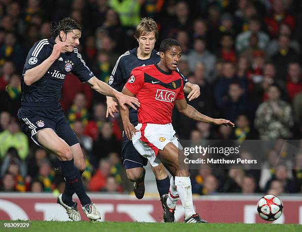 Antonio Valencia of Manchester United clashes with Daniel van Buyten and Holger Badstuber of Bayern Munich during the FA Barclays Premier League...