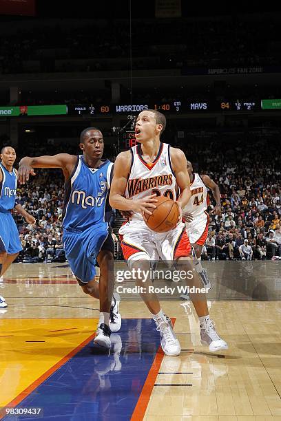 Stephen Curry of the Golden State Warriors makes a move to the basket against Rodrigue Beaubois of the Dallas Mavericks during the game at Oracle...