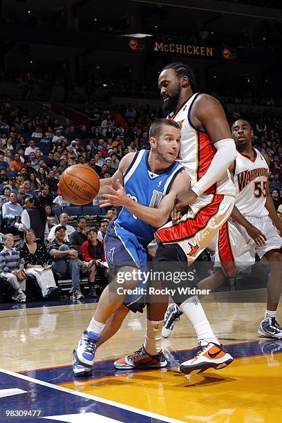 Jose Barea of the Dallas Mavericks drives to the basket against Ronny Turiaf of the Golden State Warriors during the game at Oracle Arena on March...