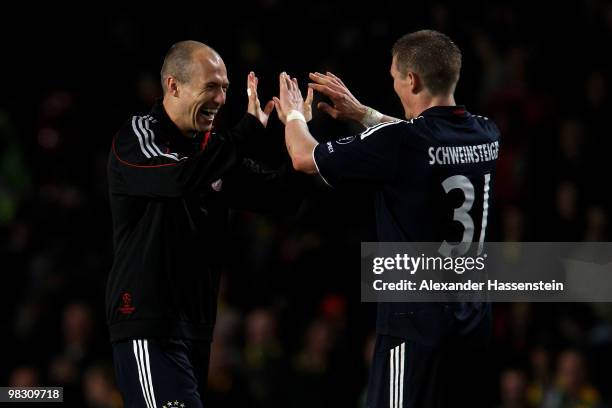 Arjen Robben of Bayern Muenchen celebrates with team mate Bastian Schweinsteiger at the end of the UEFA Champions League Quarter Final second leg...