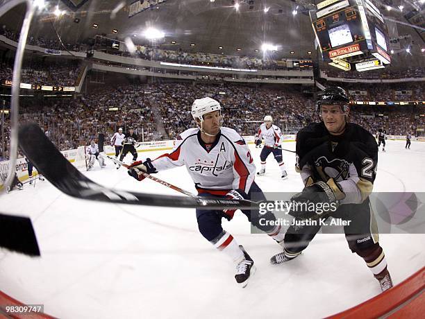 Matt Cooke of the Pittsburgh Penguins and Mike Knuble of the Washington Capitals battle for a puck along the boards at Mellon Arena on April 6, 2010...