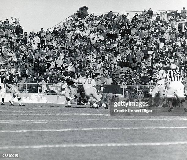 Paul Hornung of the Green Bay Packers carries the ball against Sam Huff and Jimmy Patton of the New York Giants as Jim Taylor and Dick Lynch look on...