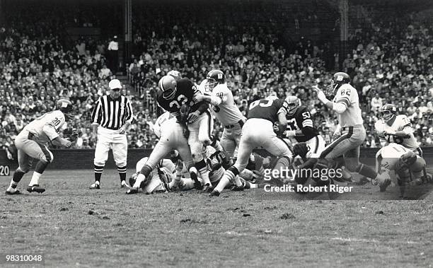 Jim Brown of the Cleveland Browns fights off Sam Huff of the New York Giants as Jimmy Patton pursues the play during the game against the New York...