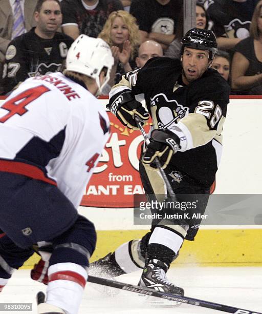 Maxime Talbot of the Pittsburgh Penguins follows through on a shot against the Washington Capitals at Mellon Arena on April 6, 2010 in Pittsburgh,...