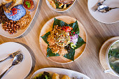 Lahpet is Burmese Tea Leaf Salad served with deep fried garlic, peanut, white sesame, dried shrimp, ginger and roasted coconut.