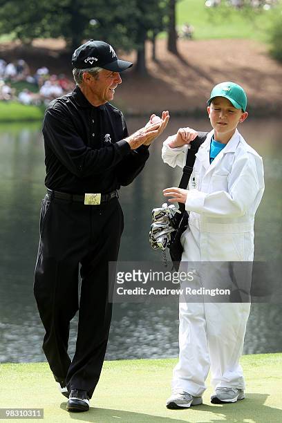 Gary Player of South Africa talks with his caddie during the Par 3 Contest prior to the 2010 Masters Tournament at Augusta National Golf Club on...
