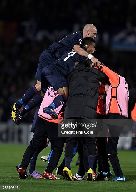 Michel Bastos and Cris of Olympique Lyonnais celebrate with team mates after winning the UEFA Champions League quarter final second leg match between...