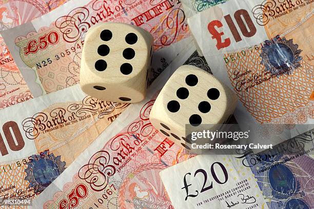 two dice, two sixes, background of pound notes. - ten pound note ストックフォトと画像