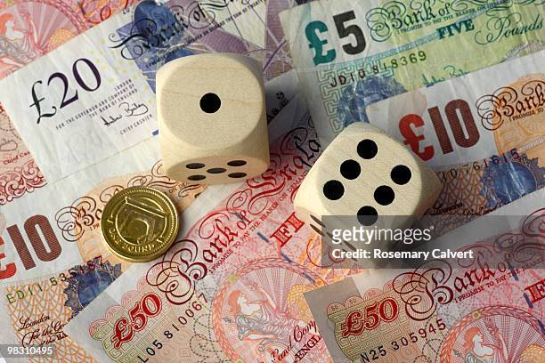 two dice, one and six, pound coin and notes - ten pound note ストックフォトと画像