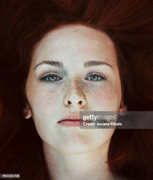 portrait of a young woman with freckles. - jovanat stock pictures, royalty-free photos & images