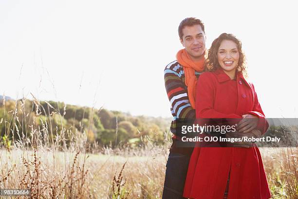 couple hugging in rural field - robert a daly bildbanksfoton och bilder