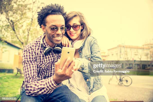 happy coouple with mobile phone - happy mobile stockfoto's en -beelden