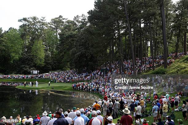 Gallery of fans watch Arnold Palmer, Jack Nicklaus and Gary Player of South Africa during the Par 3 Contest prior to the 2010 Masters Tournament at...