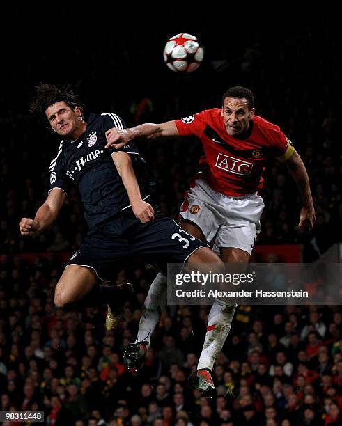 Mario Gomez of Bayern Muenchen goes up for a header with Rio Ferdinand of Manchester United during the UEFA Champions League Quarter Final second leg...