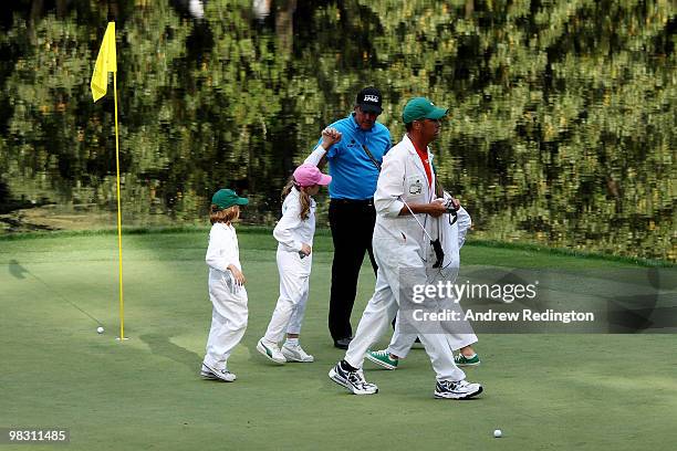 Phil Mickelson celebrates with his caddies/children Evan, Sophia and Amanda as caddie Jim MacKay walks on during the Par 3 Contest prior to the 2010...