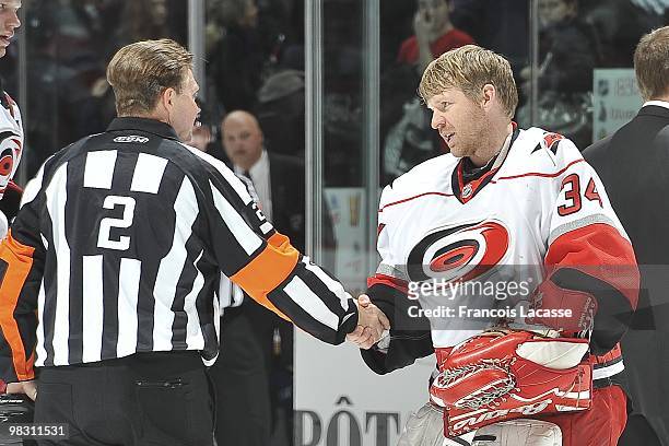 Manny Legace of the Carolina Hurricanes shakes the hand of Referee Kerry Fraser after the latter's last game during the NHL game on March 31, 2010 at...