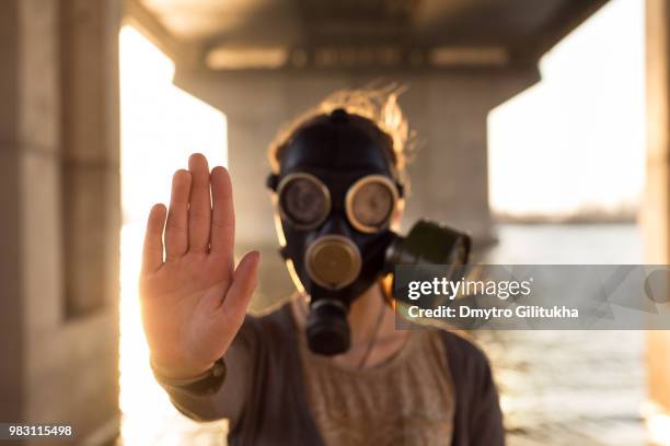 ecological concept of air contamination. woman in gas mask - air respirator mask stock pictures, royalty-free photos & images