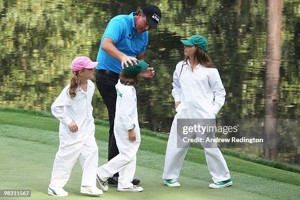 Phil Mickelson walks with his caddies/children Sophi, Evan and Amanda during the Par 3 Contest prior to the 2010 Masters Tournament at Augusta...