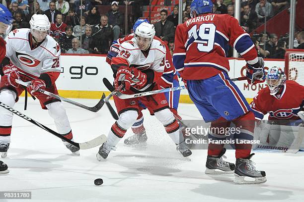 Patrick Dwyer of the Carolina Hurricanes battles for the puck with Andrei Markov of Montreal Canadiens during the NHL game on March 31, 2010 at the...