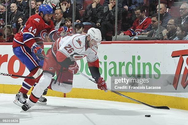 Roman Hamrlik of Montreal Canadiens battles for the puck with Erik Cole of the Carolina Hurricanes during the NHL game on March 31, 2010 at the Bell...