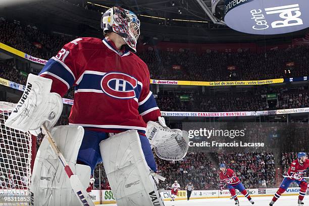 Carey Price of Montreal Canadiens looks at the action during the NHL game against the Carolina Hurricanes on March 31, 2010 at the Bell Center in...